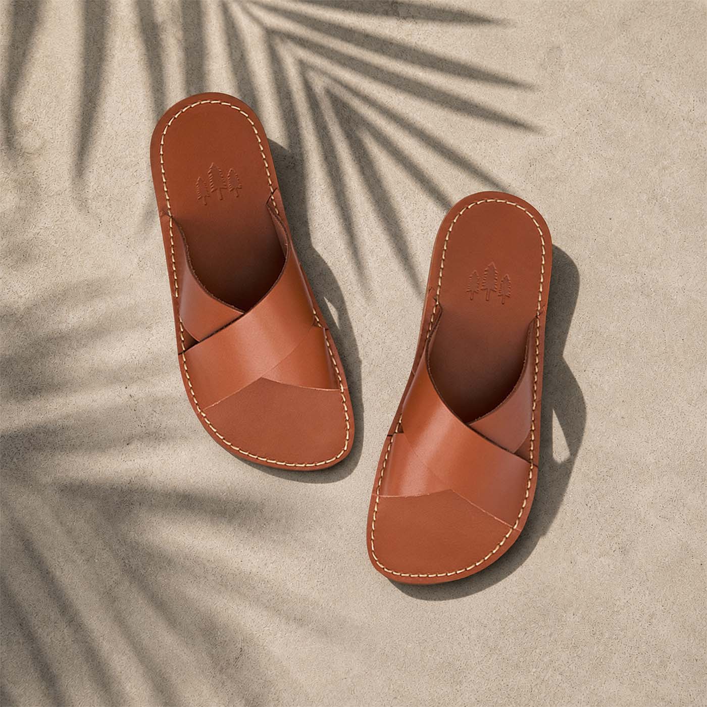 Miele | Tan brown leather flat sandals with debossed Portland Leather trees logo