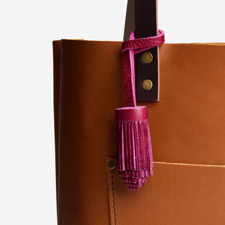 All Color: Orchid | Pom-pom style with tiered leather fringe