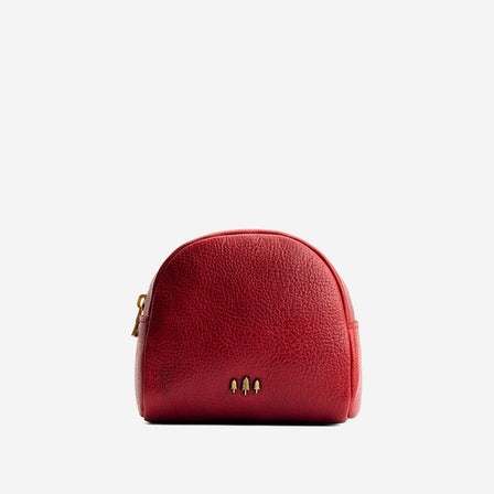 Chili Red | Curved top leather pouch with zipper opening, flat base, and three metal tree emblems in front