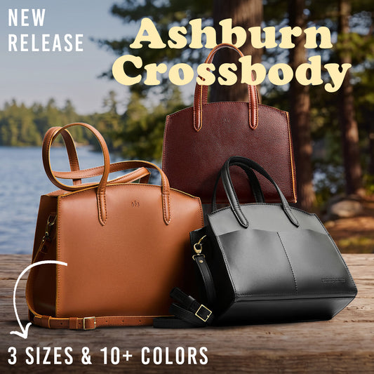 Three leather handbags are displayed outdoors on a wooden surface with a lake and trees in the background. Large text reads 'Ashburn Crossbody' and 'NEW RELEASE,' with additional text noting '3 SIZES & 10+ COLORS.