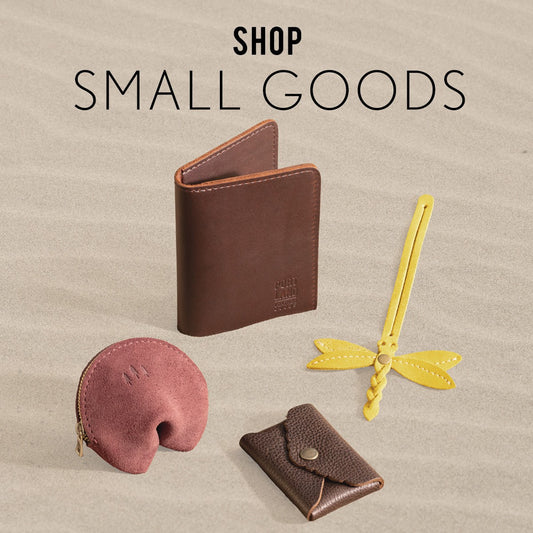 Small leather goods on a sandy beach.