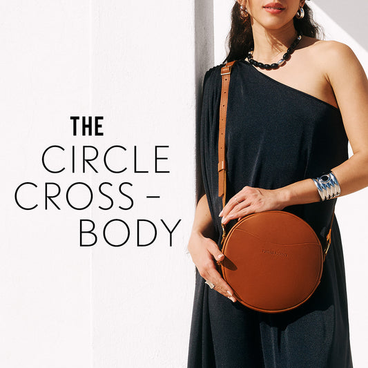 Model holding a Honey Circle Crossbody bag on a white background 