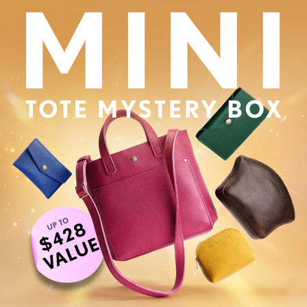 Promotional graphic for a 'Mini Tote Mystery Box' featuring a collection of totes, wallets, and small goods. Set against a sparkly background with a pink badge indicating up to $428 value.