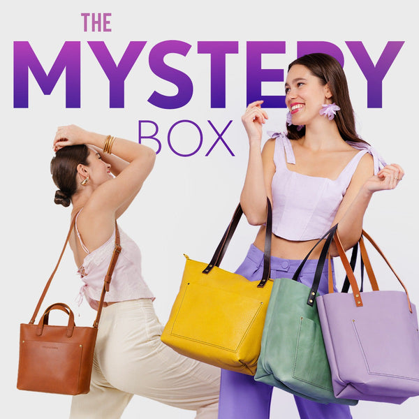 Two women holding colorful Mini Crossbodies and Leather Tote Bags with 'The Mystery Box' text above.