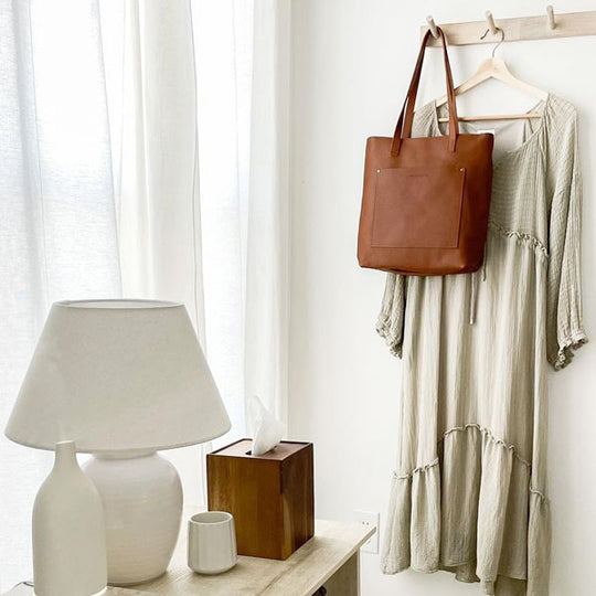 Crossbody Tote hanging in a stylish room.