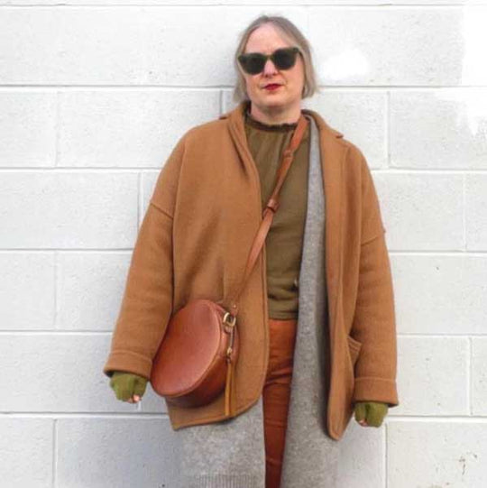 Woman wearing sunglasses and leather crossbody bag