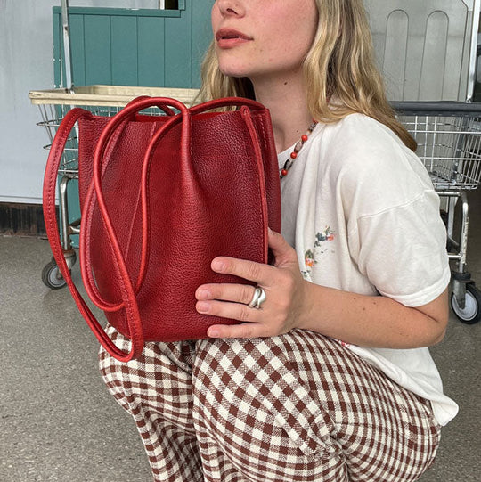 Person hold Chili Red Devan Bucket Bag