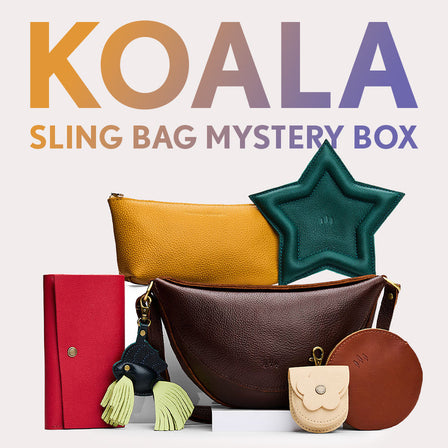 Koala Sling Bag in Coldbrew next to Blooming Wristlet, Daisy Plus Wallet, Luna Pouch, and Leather Wrap Journal. Text reads "Koala Sling Bag Myster Box"