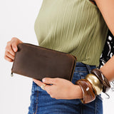 Canyon | Model holding large accordion leather wallet with zipper closed