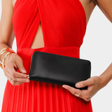 Black | Model holding large accordion leather wallet with zipper closed