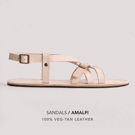 Crema | Person wearing strappy leather sandals with two buckle accents