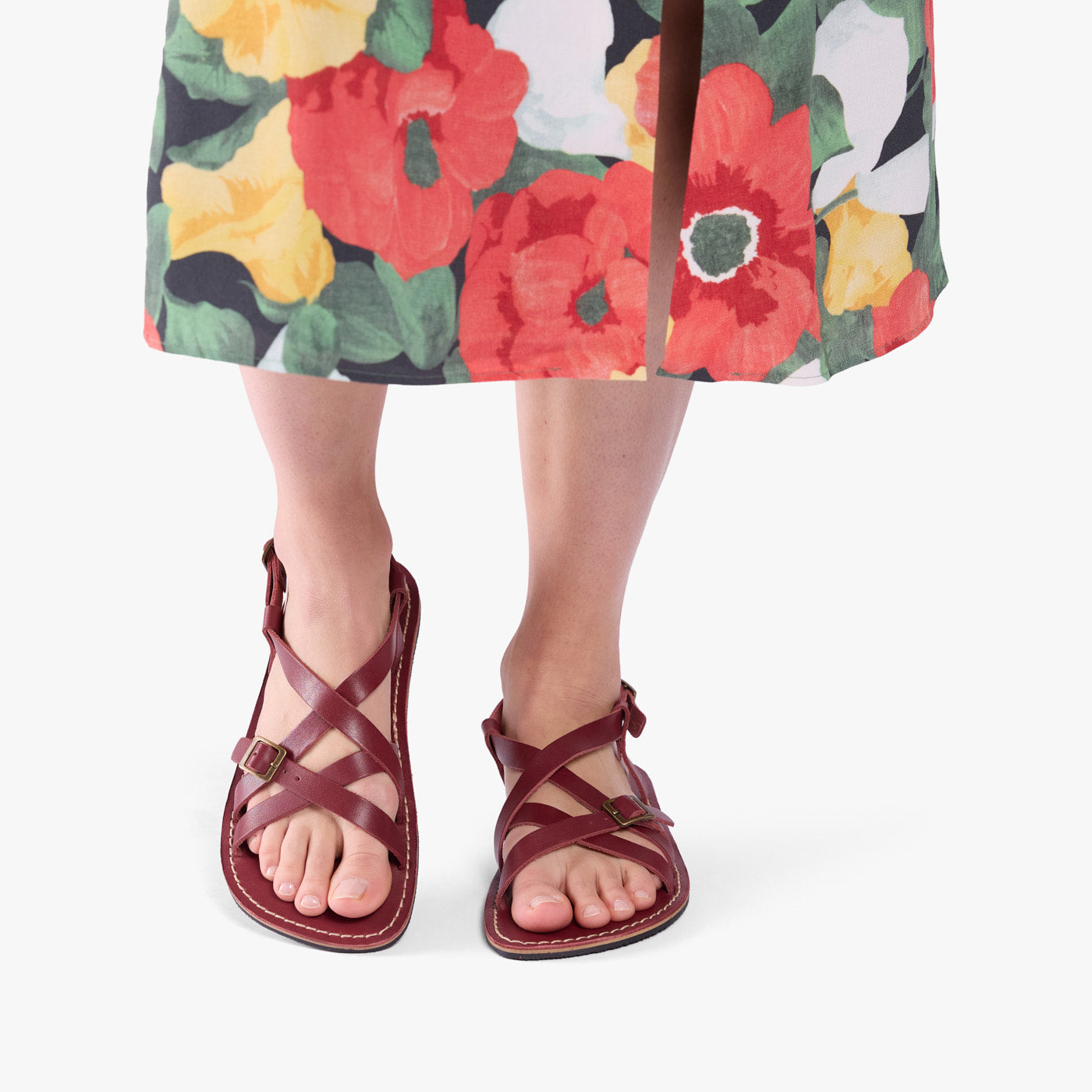 Marsala | Person wearing strappy leather sandals with two buckle accents