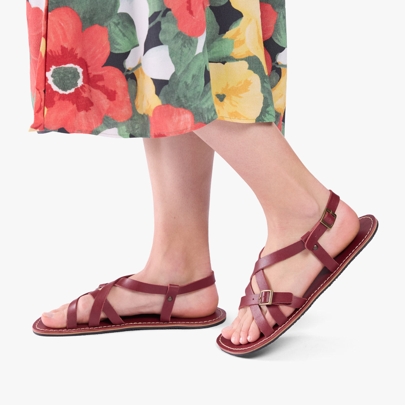 Marsala | Person wearing strappy leather sandals with two buckle accents