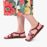 Marsala | Person wearing strappy leather sandals with two buckle accents