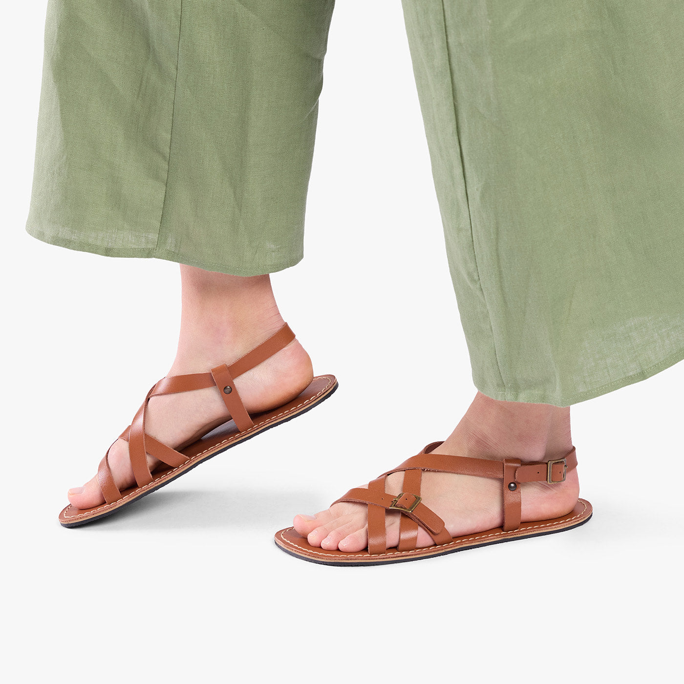 Miele | Person wearing strappy leather sandals with two buckle accents