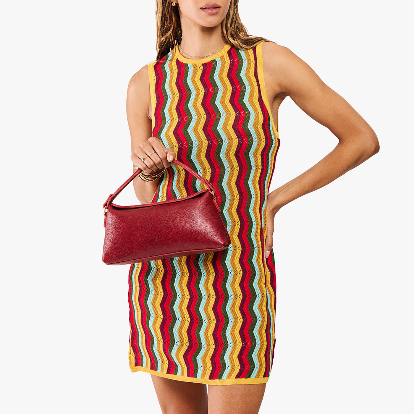 Chili Red | Model holding a red bowler style hand bag 