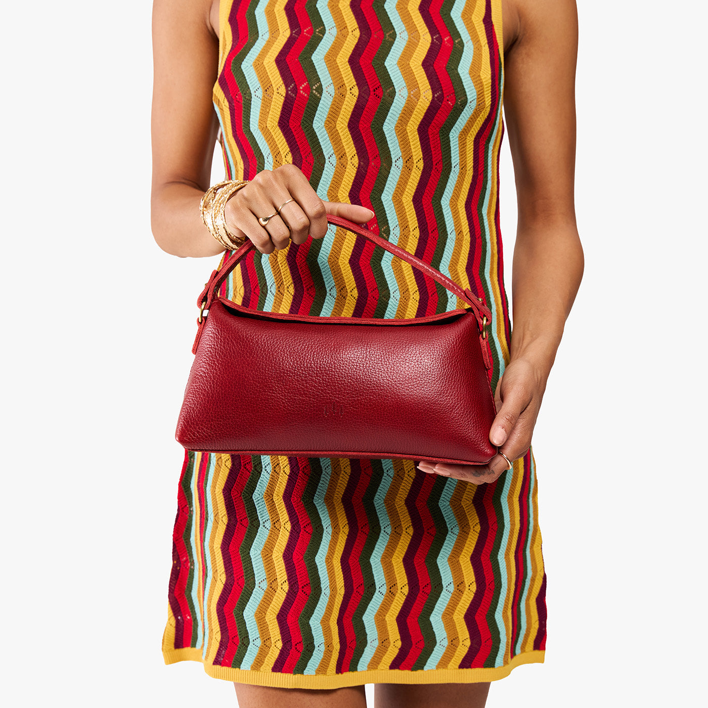 Chili Red | Model holding a red bowler style hand bag 
