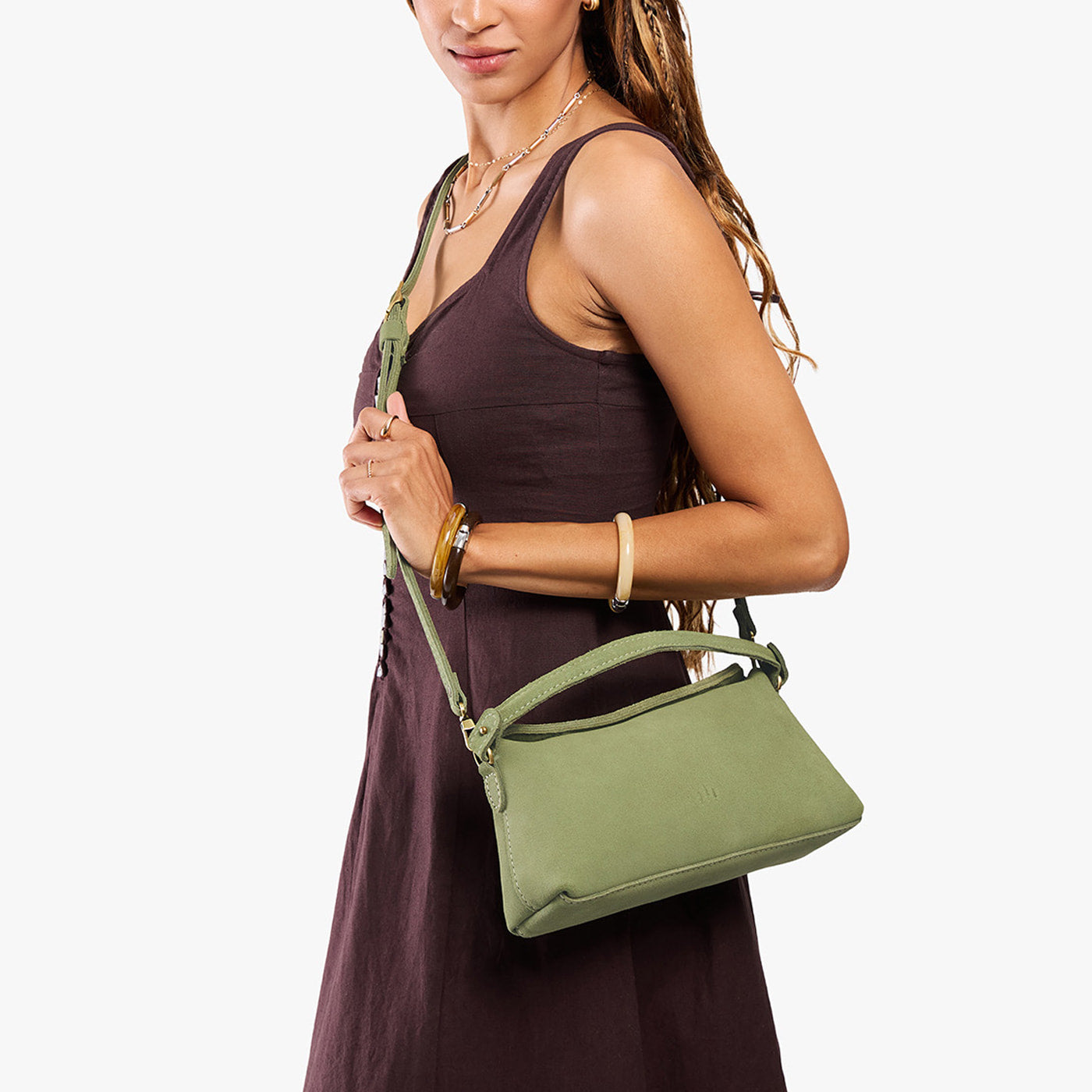 Laurel | Model holding a light green bowler style hand bag 