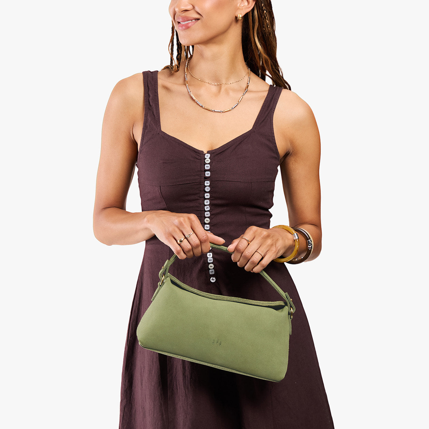 Laurel | Model holding a light green bowler style hand bag 