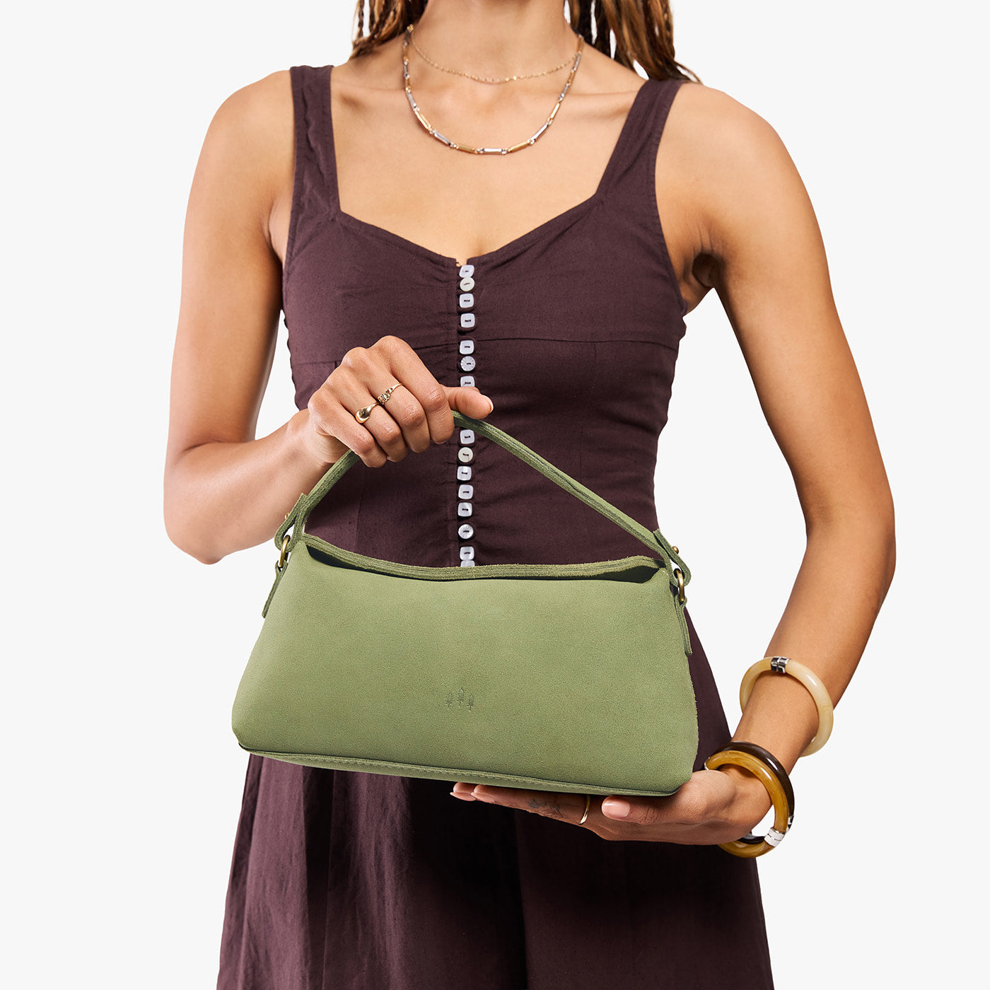 Laurel | Model holding a light green bowler style hand bag 