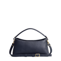 Night Owl | Leather bowler bag with magnetic closure against a white background