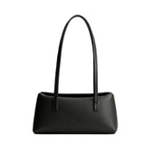 Black | Leather bowler bag with magnetic closure against a white background