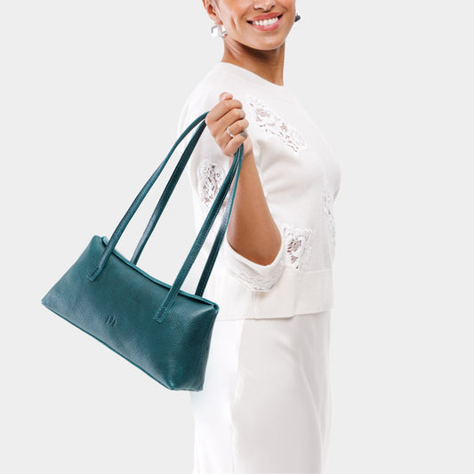 Lagoon | Person holding leather bowler bag with magnetic closure