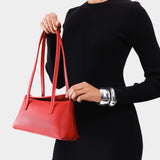Ruby | Person holding leather bowler bag with magnetic closure
