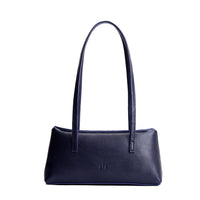 Cobalt | Leather bowler bag with magnetic closure against a white background