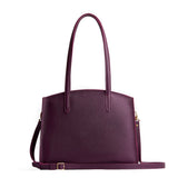 Plum Large | Leather tote bag with handles, adjustable crossbody strap, zipper top, and two back pockets