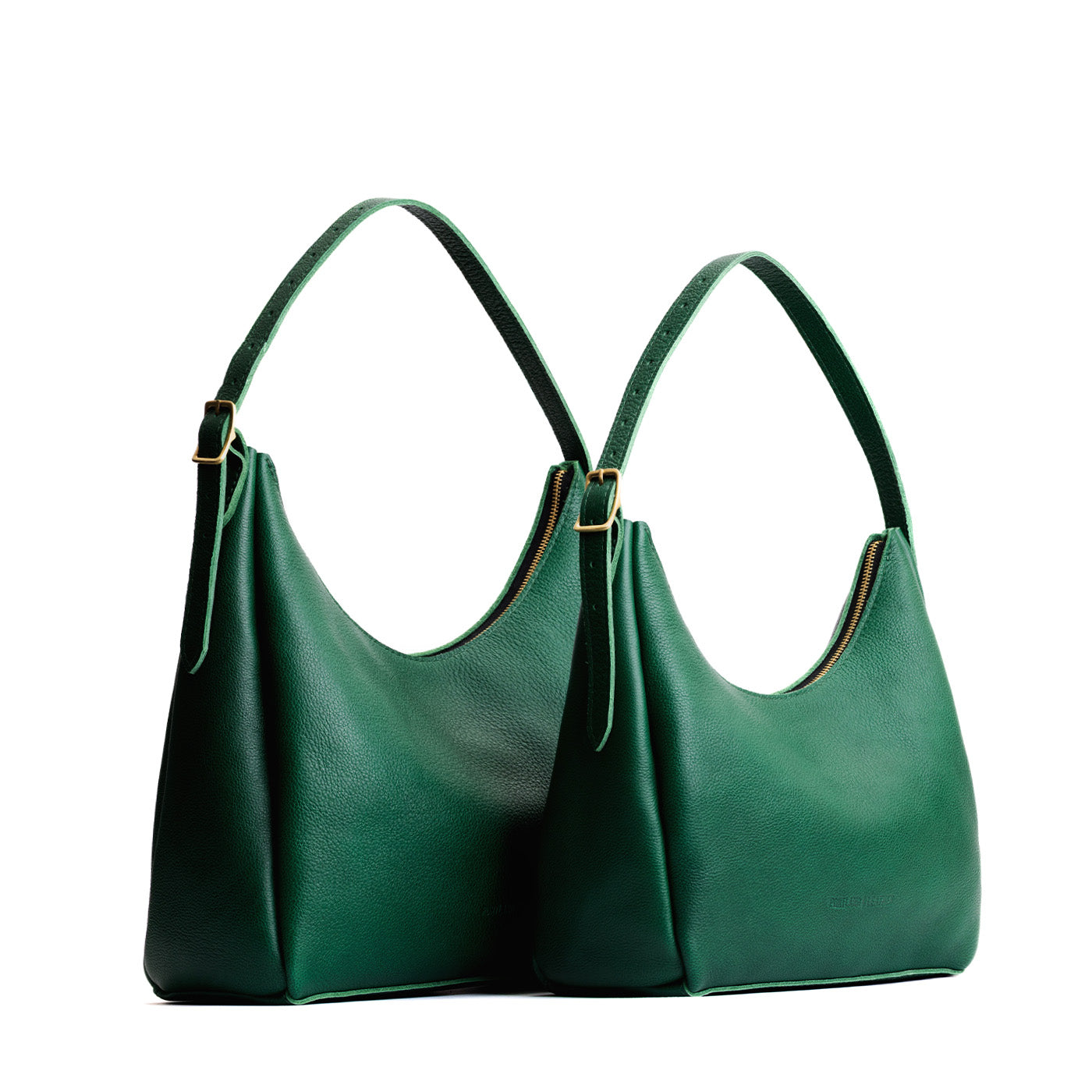 Bacalar | Size comparison image of large and medium u-shaped, flat-bottomed leather shoulder bags with adjustable strap