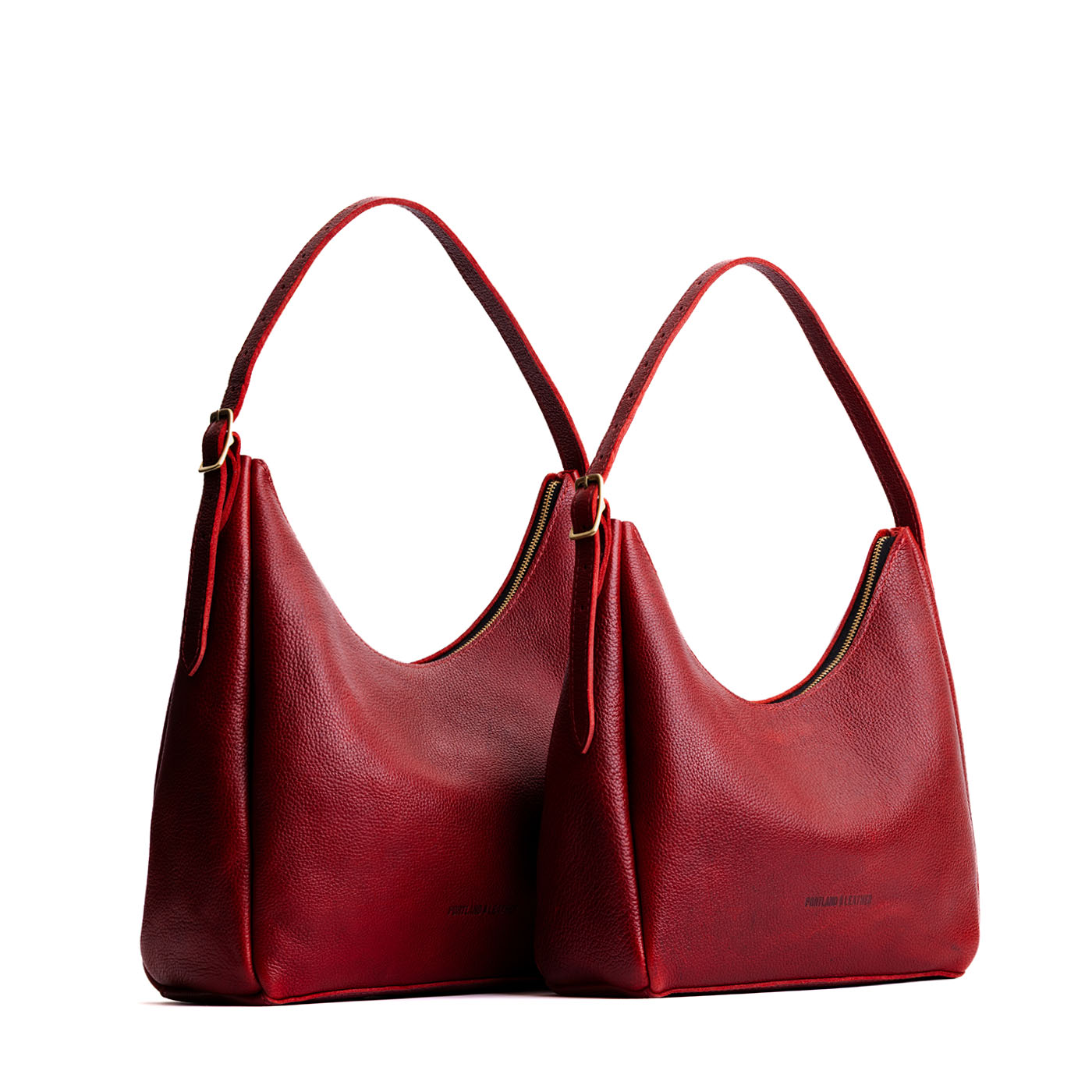 Chili Red | Size comparison image of large and medium u-shaped, flat-bottomed leather shoulder bags with adjustable strap
