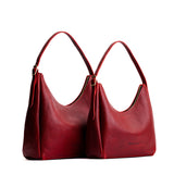 Chili Red | Size comparison image of large and medium u-shaped, flat-bottomed leather shoulder bags with adjustable strap