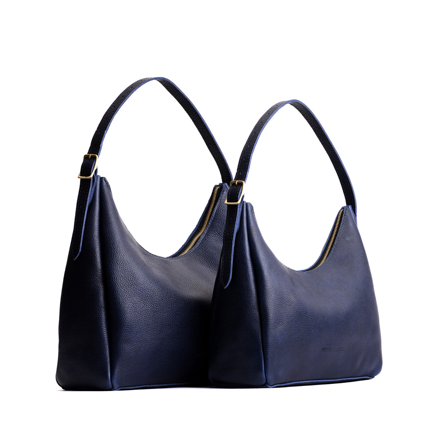 Cobalt | Size comparison image of large and medium u-shaped, flat-bottomed leather shoulder bags with adjustable strap
