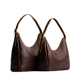 Coldbrew | Size comparison image of large and medium u-shaped, flat-bottomed leather shoulder bags with adjustable strap