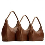 Asheville | Size comparison image of oversized, large, and medium u-shaped, flat-bottomed leather shoulder bags with adjustable strap