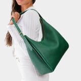 Bacalar Large | Model holding u-shaped, flat-bottomed leather shoulder bag with adjustable strap