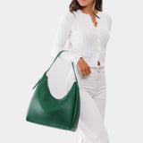 Bacalar Large | Model holding u-shaped, flat-bottomed leather shoulder bag with adjustable strap