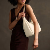 Pebbled Bone Medium | U-shaped, flat-bottomed leather shoulder bag with adjustable strap