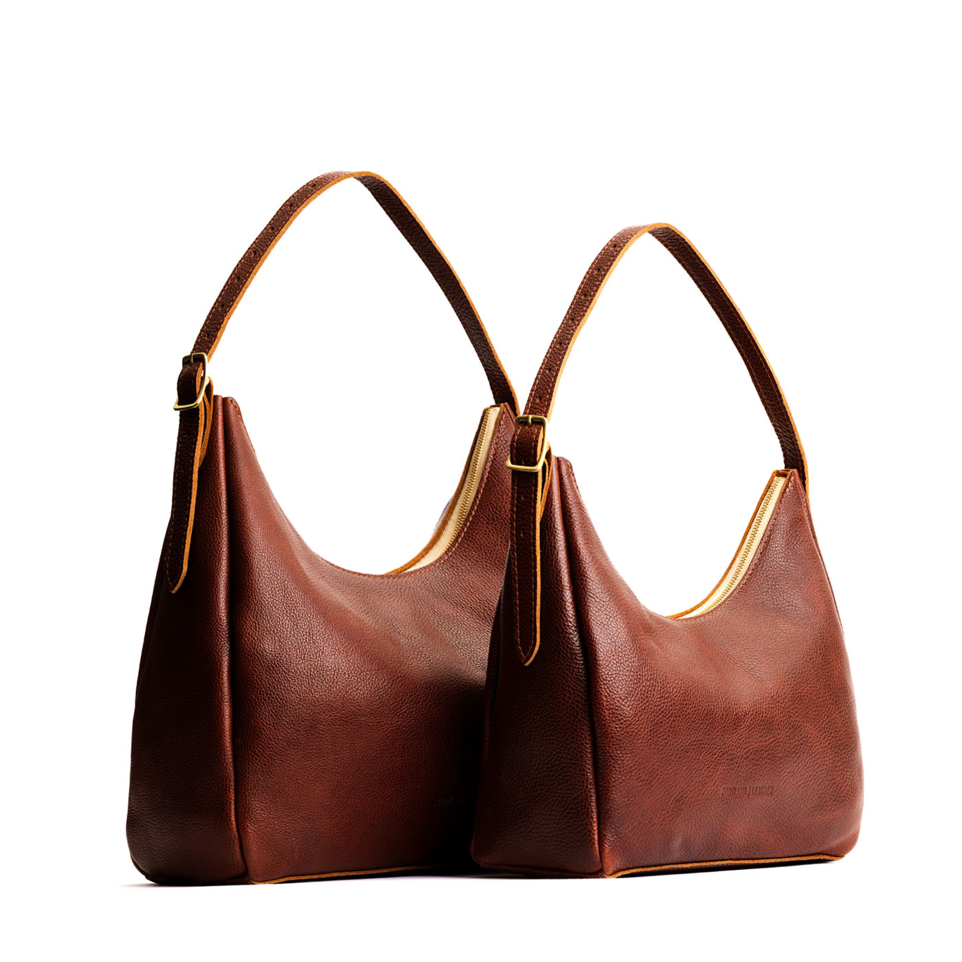 Nutmeg | Size comparison image of large and medium u-shaped, flat-bottomed leather shoulder bags with adjustable strap