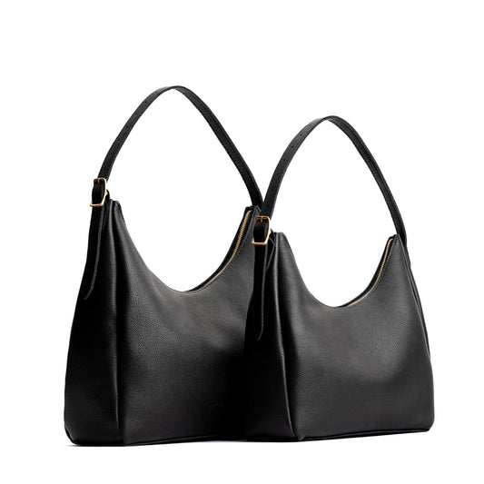 Pebbled--black | Size comparison image of large and medium u-shaped, flat-bottomed leather shoulder bags with adjustable strap