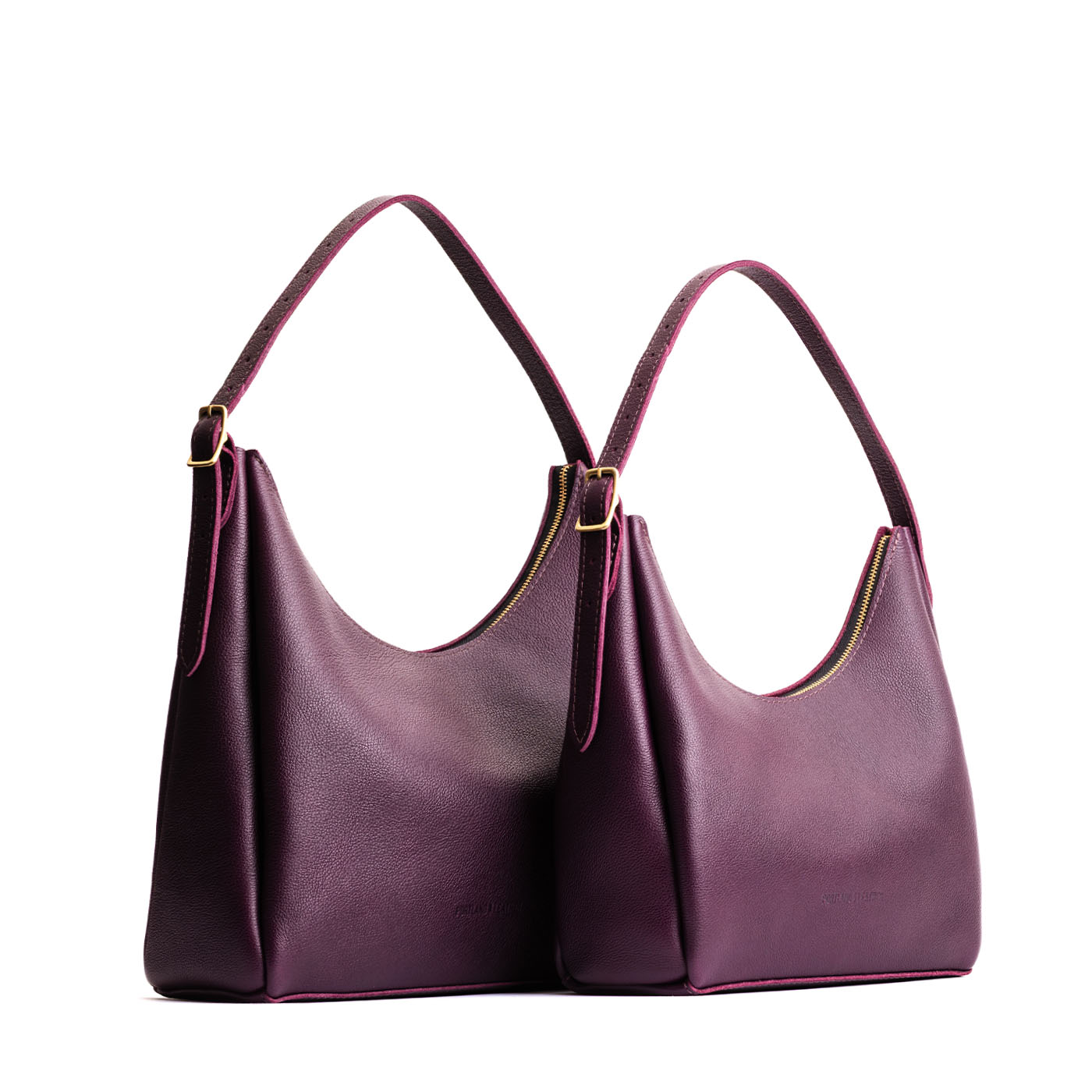 Plum | Size comparison image of large and medium u-shaped, flat-bottomed leather shoulder bags with adjustable strap