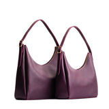 Plum | Size comparison image of large and medium u-shaped, flat-bottomed leather shoulder bags with adjustable strap