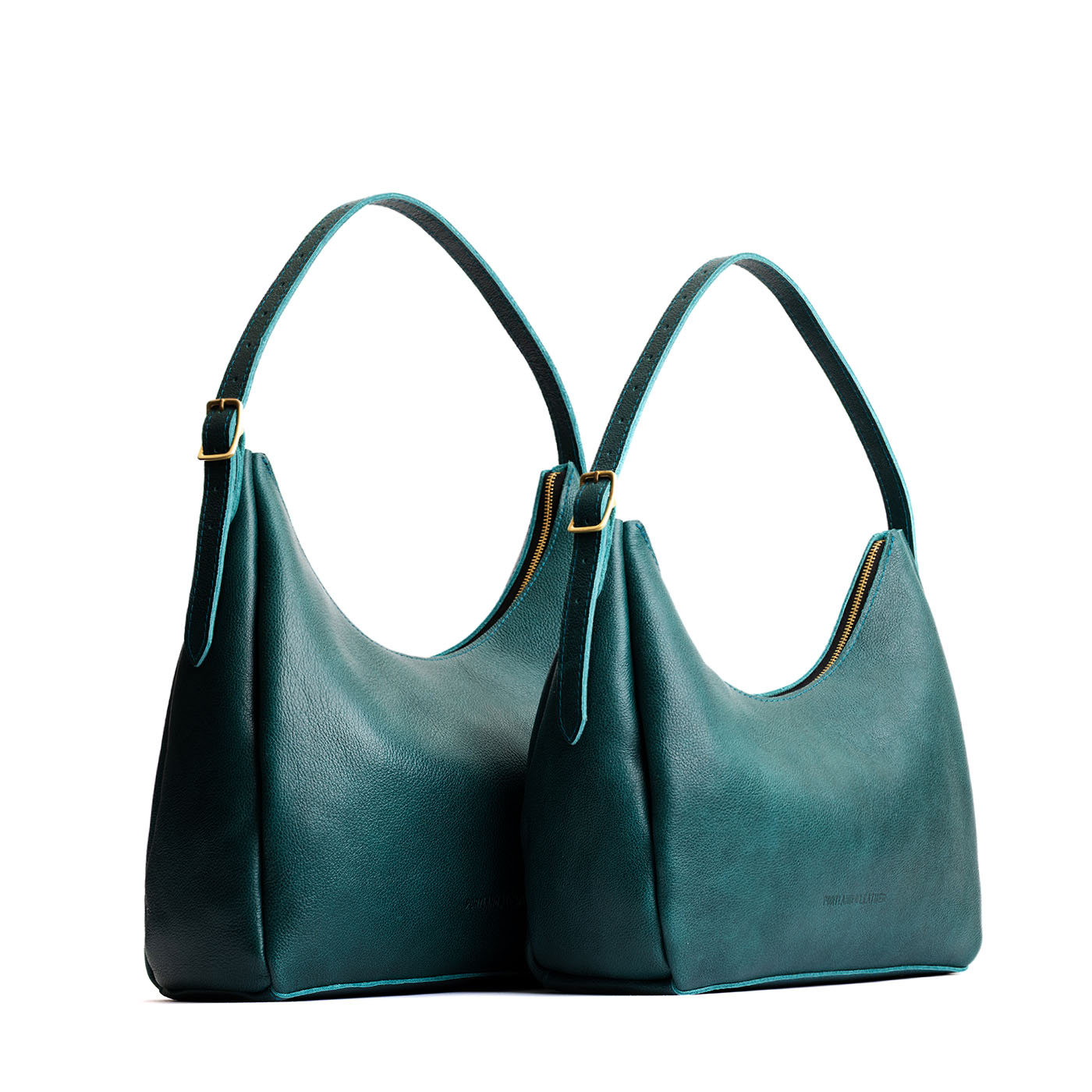 Sea Glass | Size comparison image of large and medium u-shaped, flat-bottomed leather shoulder bags with adjustable strap