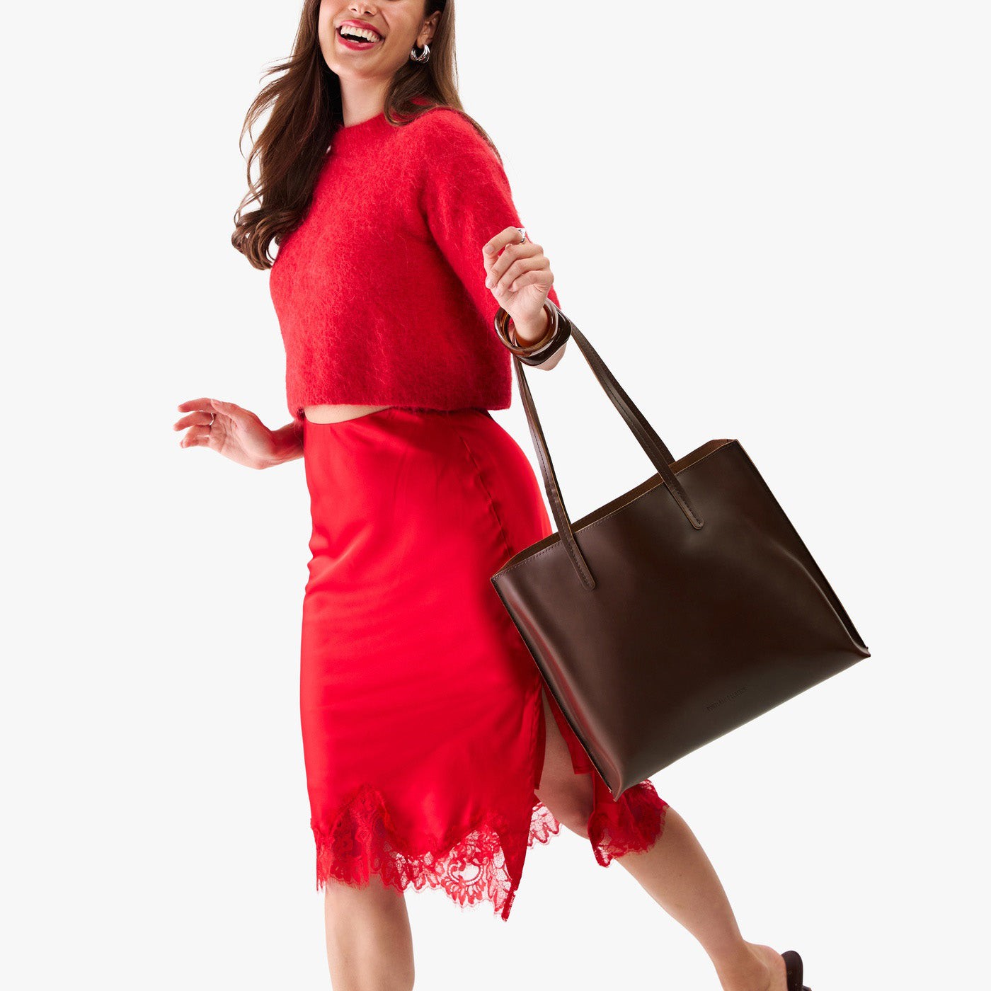 Chocolate Brown*Large | Model holding leather tote bag with interior snap key loop