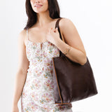 Coldbrew Large | Model holding leather tote bag with interior snap key loop