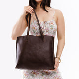 Coldbrew Large | Model holding leather tote bag with interior snap key loop