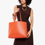 Koi Large | Model holding leather tote bag with matching leather handles