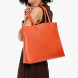 Koi Large | Model carrying leather tote bag with matching leather handles