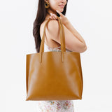 Mango Large | Model holding leather tote bag with interior snap key loop